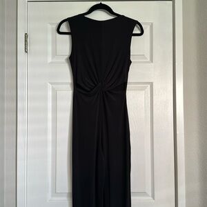 Misguided long black jumpsuit with cutouts near rib section.
